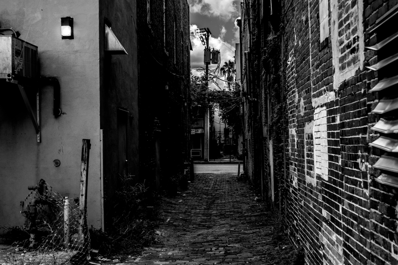 This alley still smelled of Saturday night.